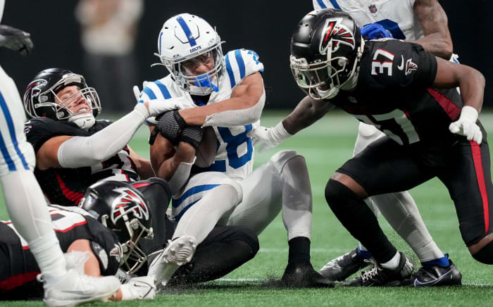 Indianapolis Colts running back Jonathan Taylor (28) is brought down by Atlanta Falcons defenders during a game against at Mercedes-Benz Stadium.